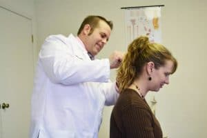 Chiropractor 77095 TX Scott William Stelmach Adjusting Patient's Neck